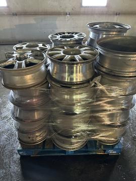 Stacked Aluminum Wheels Ready for Recycling at Scrap Metal Facility