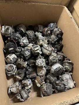 Scrap Metal Recycling: Collection of Used Alternators in Cardboard Box